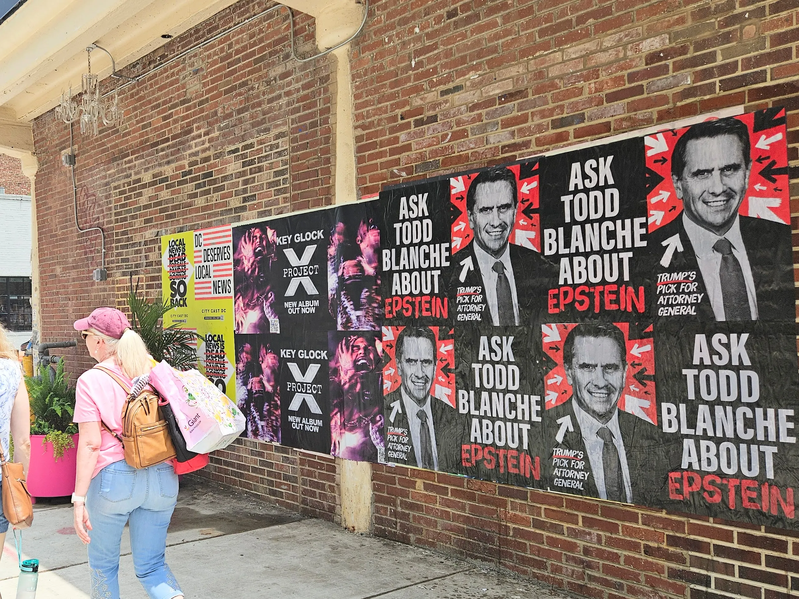 Home of the Brave “Ask Todd Blanche about Epstein” posters wheat-pasted on walls and storefronts around Washington, DC.