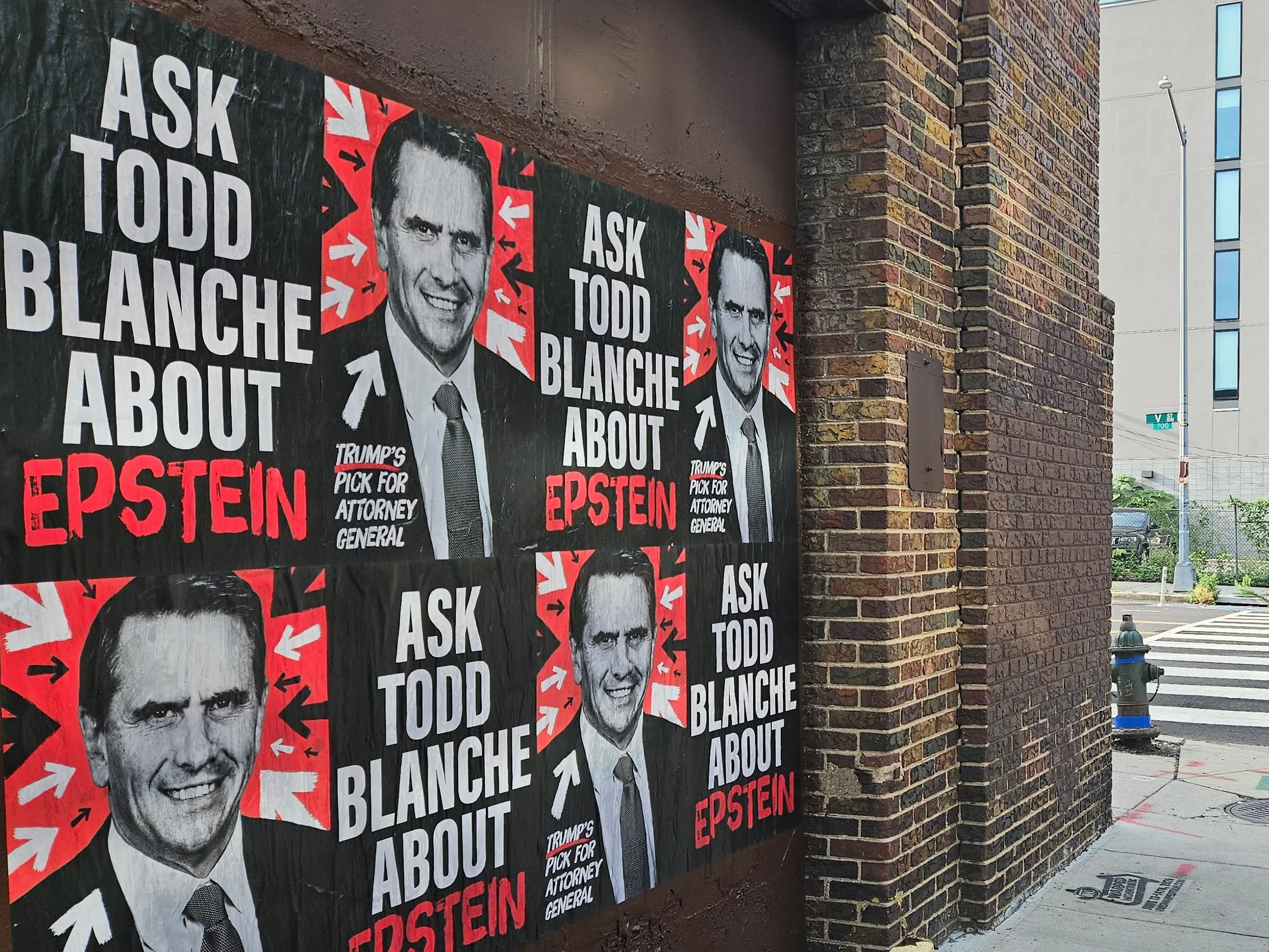 Home of the Brave “Ask Todd Blanche about Epstein” posters wheat-pasted on walls and storefronts around Washington, DC.
