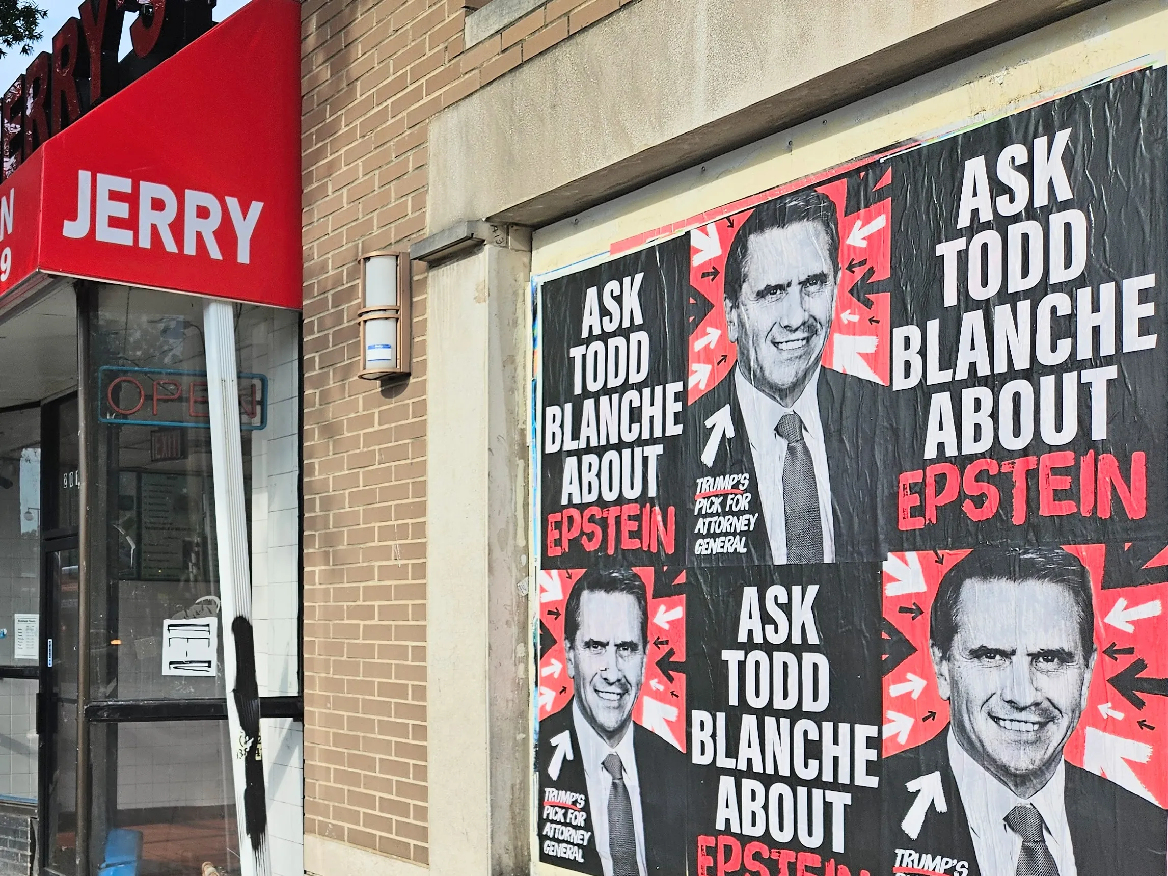 Home of the Brave “Ask Todd Blanche about Epstein” posters wheat-pasted on walls and storefronts around Washington, DC.