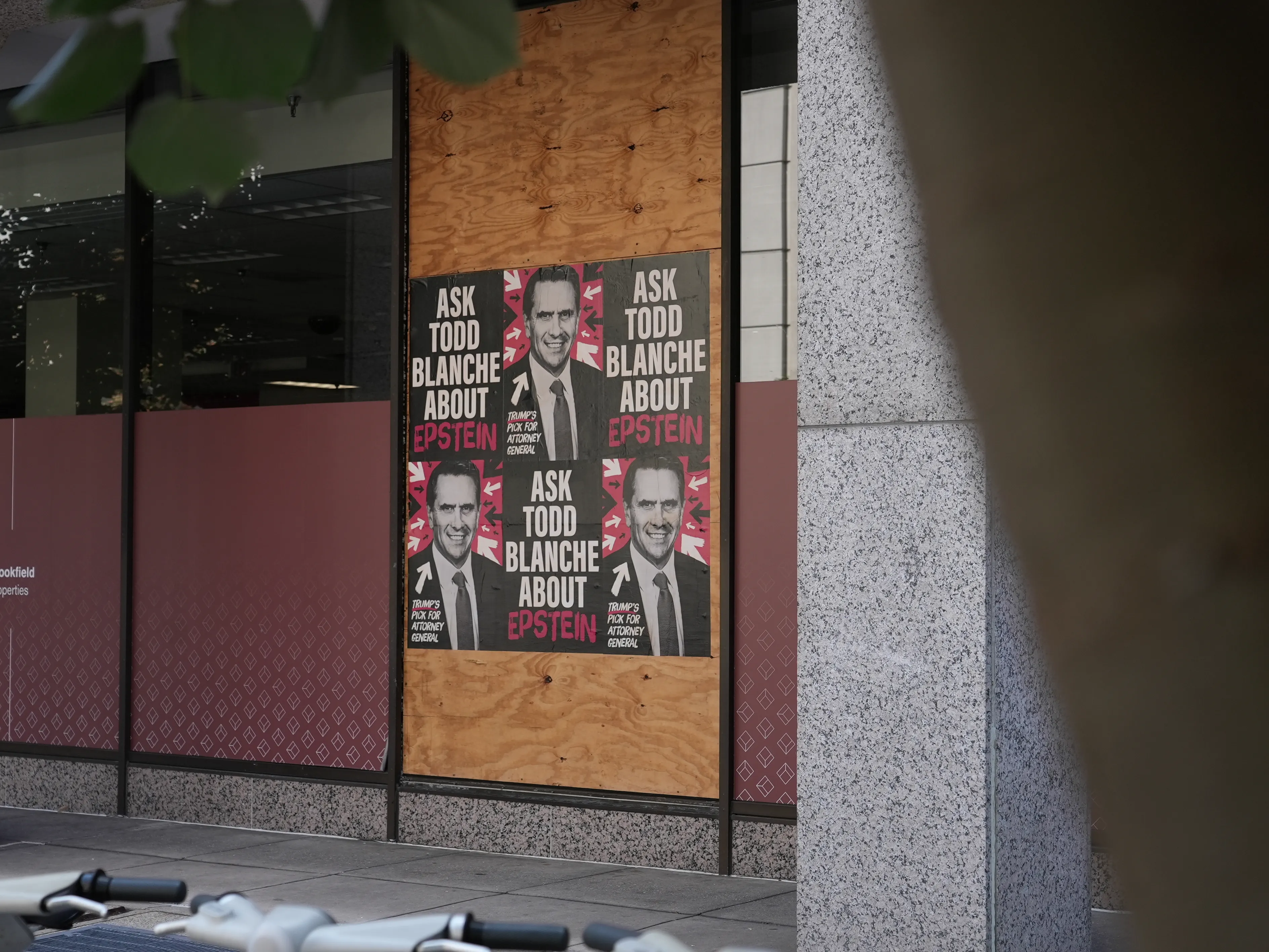 Home of the Brave “Ask Todd Blanche about Epstein” posters wheat-pasted on walls and storefronts around Washington, DC.
