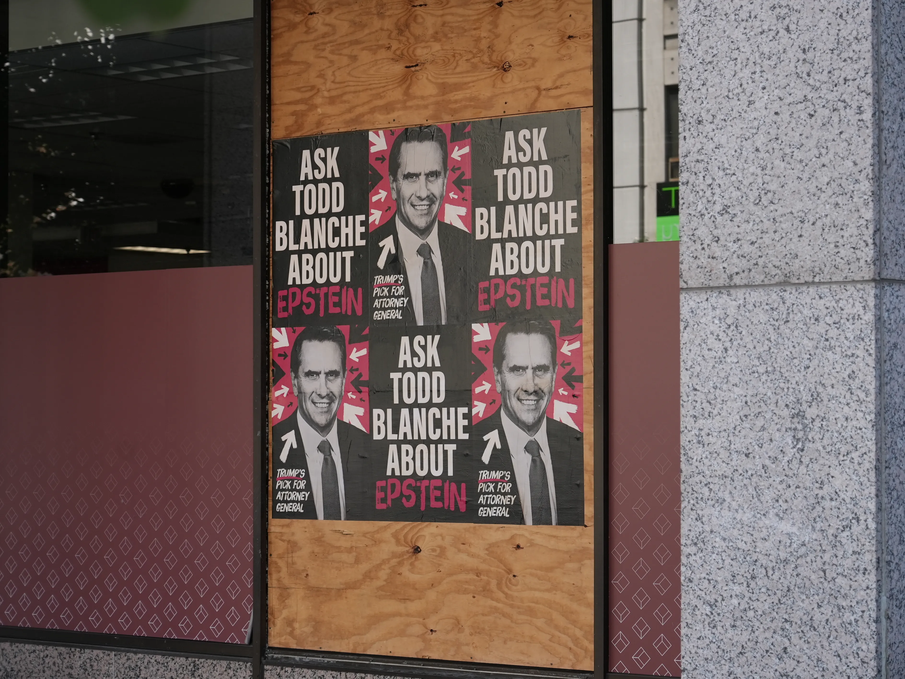 Home of the Brave “Ask Todd Blanche about Epstein” posters wheat-pasted on walls and storefronts around Washington, DC.